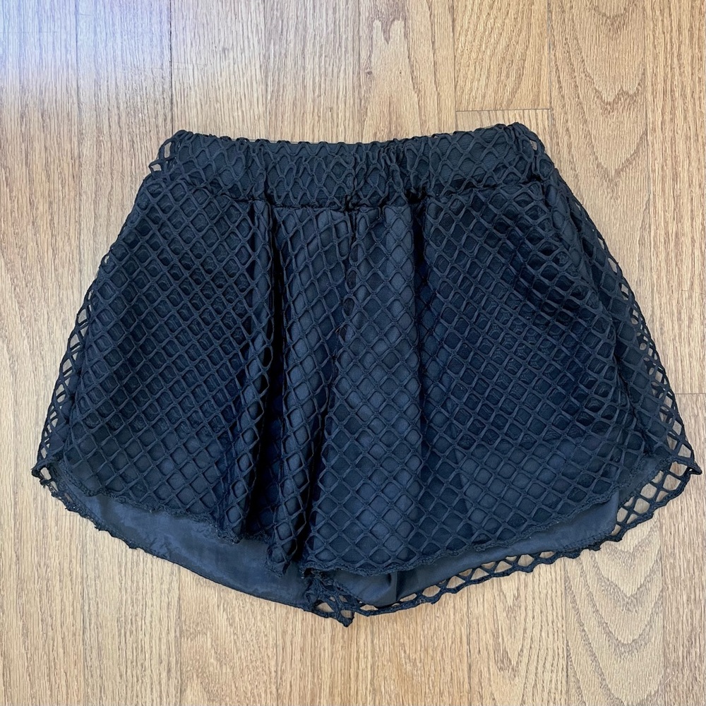 Black fishnet mesh overlay shorts with pockets